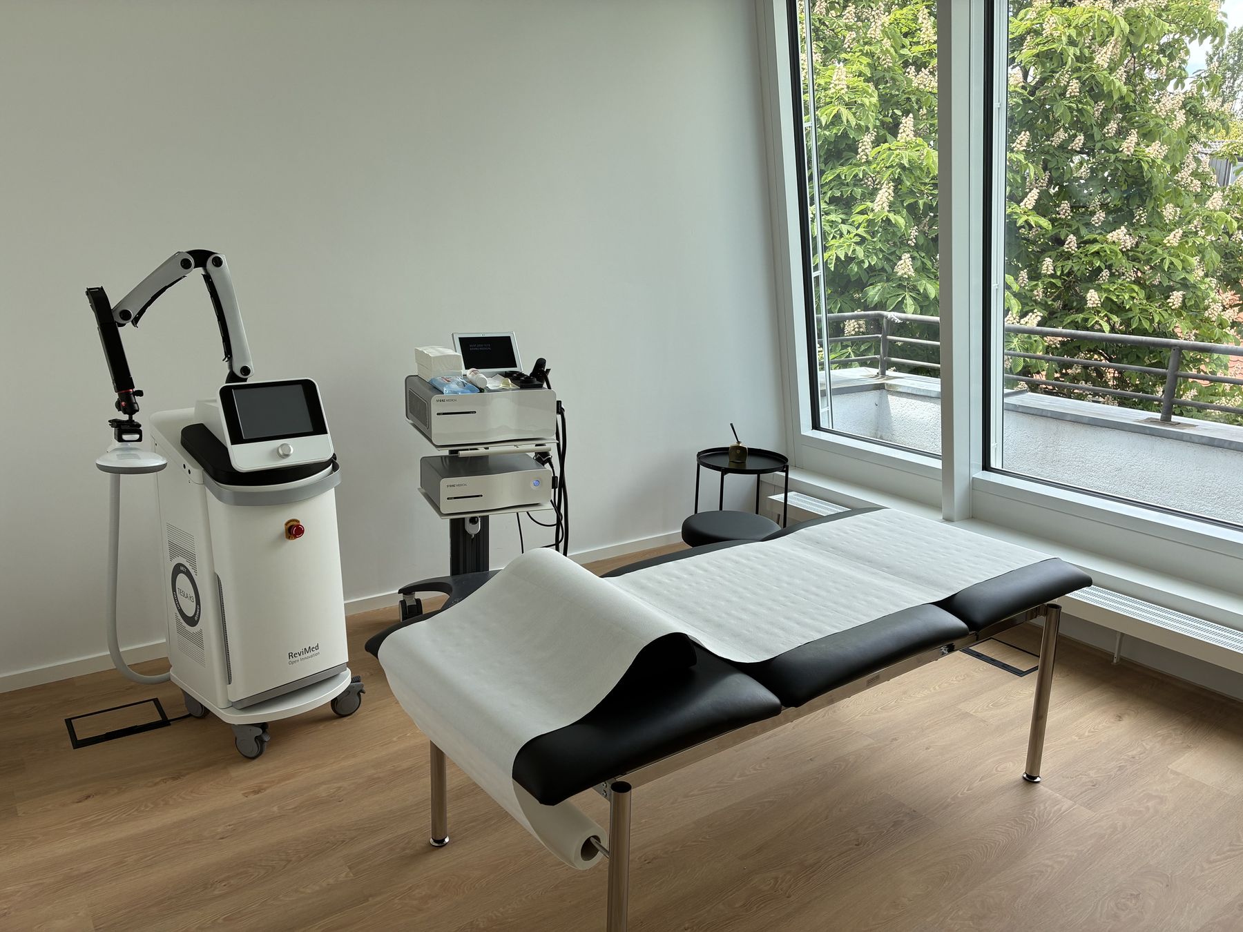 Stoßwellengerät und Behandlungsliege im Therapieraum der Orthopädie Dr. Radke in München